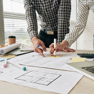 Two People working in blue prints